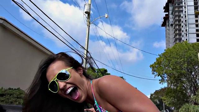 Watch this perky teen with glasses give a public handjob to a massive cock in a car