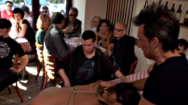 Kinky tattooed slut in bondage sucks and fucks in public eatery