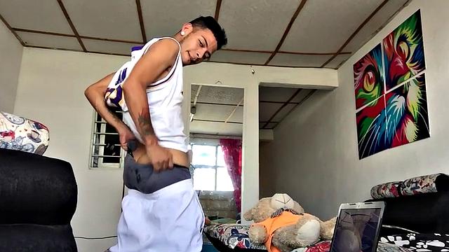 tattooed latino tugging his shaved cock