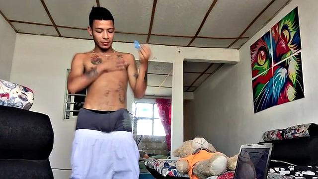 tattooed latino tugging his shaved cock