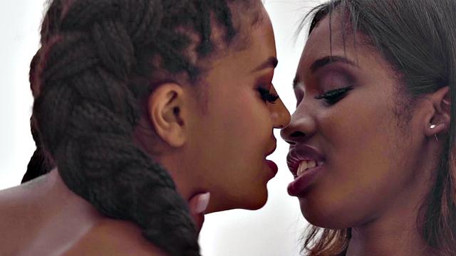 A busty ebony babe pleasure her girlfriend's pussy with some steamy fingering