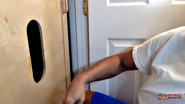 hung guy gets a blowjob through the gloryhole