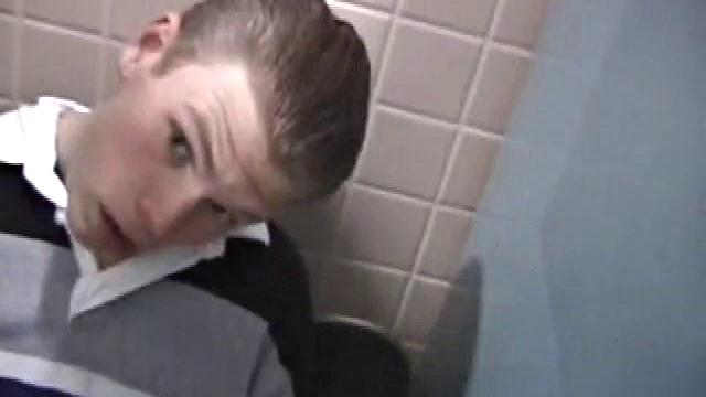 We catch up with Christian on an outdoor stairway. He leads us to a men's room with glory holes. Tere, Christian jacks off to photos in a straight porn magazine.