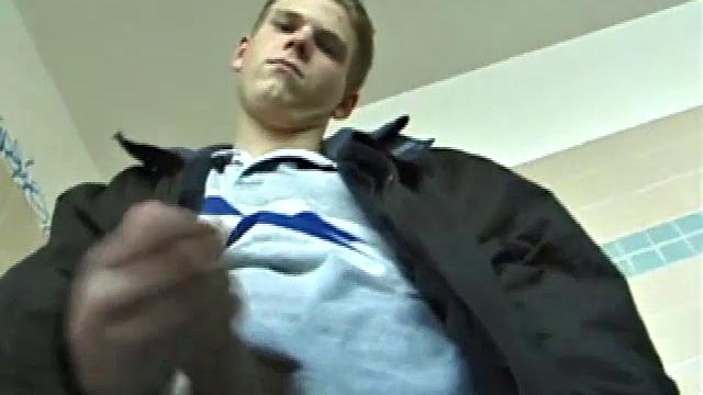 We catch up with Christian on an outdoor stairway. He leads us to a men's room with glory holes. Tere, Christian jacks off to photos in a straight porn magazine.