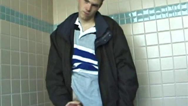 We catch up with Christian on an outdoor stairway. He leads us to a men's room with glory holes. Tere, Christian jacks off to photos in a straight porn magazine.