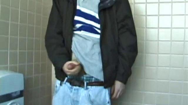 We catch up with Christian on an outdoor stairway. He leads us to a men's room with glory holes. Tere, Christian jacks off to photos in a straight porn magazine.