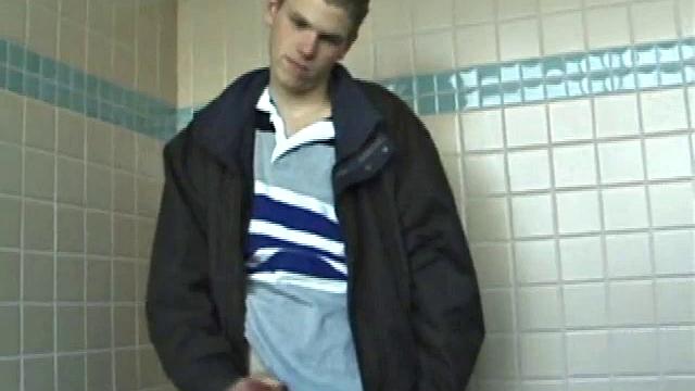 We catch up with Christian on an outdoor stairway. He leads us to a men's room with glory holes. Tere, Christian jacks off to photos in a straight porn magazine.