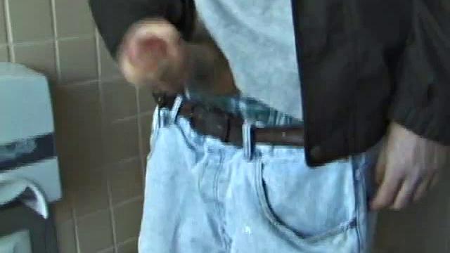 We catch up with Christian on an outdoor stairway. He leads us to a men's room with glory holes. Tere, Christian jacks off to photos in a straight porn magazine.