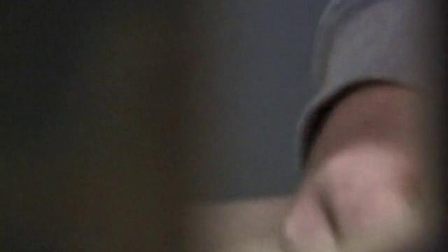 We catch up with Christian on an outdoor stairway. He leads us to a men's room with glory holes. Tere, Christian jacks off to photos in a straight porn magazine.