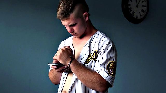 Dyron is a horny young man, who strips naked and works up a stiff one, while watching some porn on his phone. Once he's worked up and ready to go, Dyron kicks back on the bed and starts beating off.