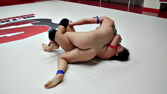 Hot tattooed lesbian dominates with fisting & strap-on play in a wrestling match