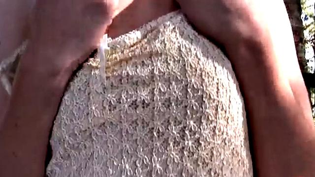 Lesbian Nina showcasing her natural tits and ass in the forest