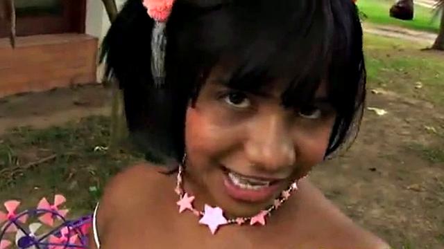 Tobie Teen gets naughty in a garden, stripping off to show her small tits and great ass. She rubs her tits and fingers pussy