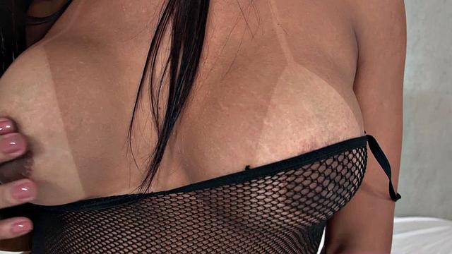 Watch this hot Brunette in lingerie tease herself with her big tits and fishnet high heels