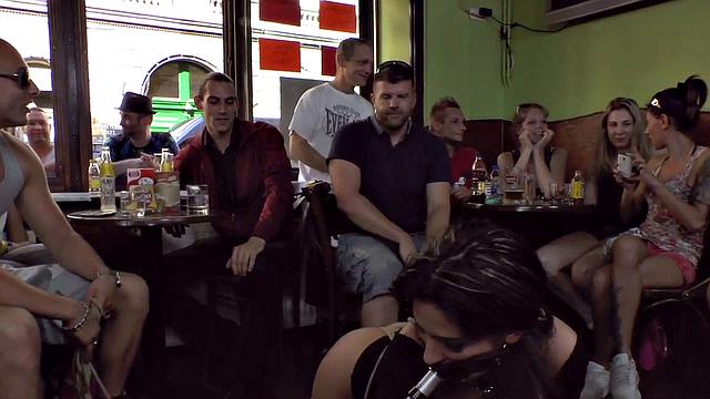 Publicly humiliated sub sucking with voyeurs watching