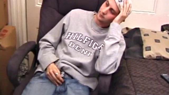 As a porn flick plays, young amateur Aaron Michaels strokes hard, pulls his cock out of his jeans, lets loose, and spills his nut on the bed.