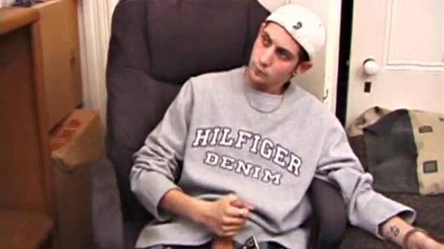 As a porn flick plays, young amateur Aaron Michaels strokes hard, pulls his cock out of his jeans, lets loose, and spills his nut on the bed.