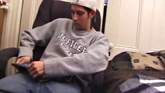 As a porn flick plays, young amateur Aaron Michaels strokes hard, pulls his cock out of his jeans, lets loose, and spills his nut on the bed.