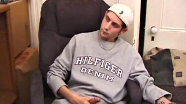 As a porn flick plays, young amateur Aaron Michaels strokes hard, pulls his cock out of his jeans, lets loose, and spills his nut on the bed.