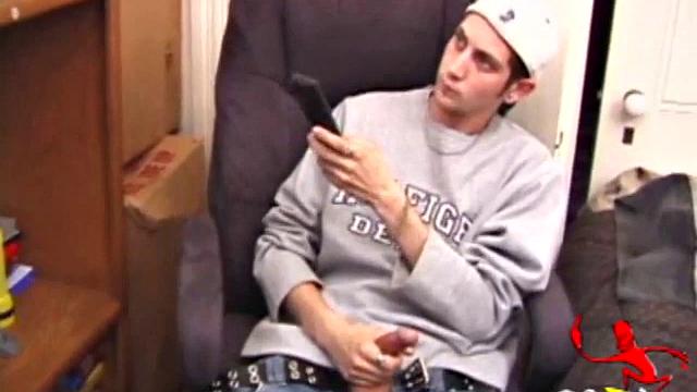 As a porn flick plays, young amateur Aaron Michaels strokes hard, pulls his cock out of his jeans, lets loose, and spills his nut on the bed.