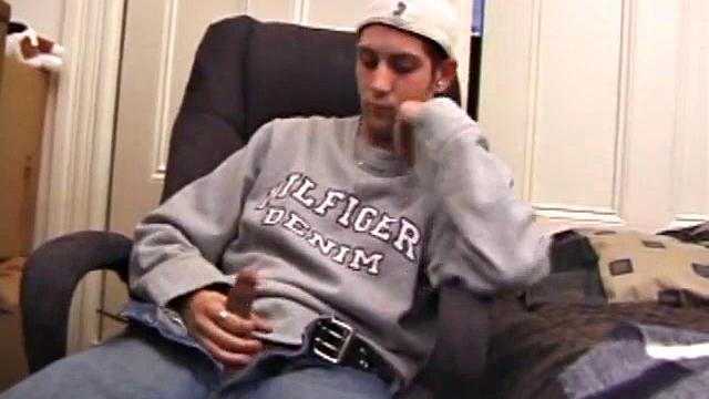 As a porn flick plays, young amateur Aaron Michaels strokes hard, pulls his cock out of his jeans, lets loose, and spills his nut on the bed.