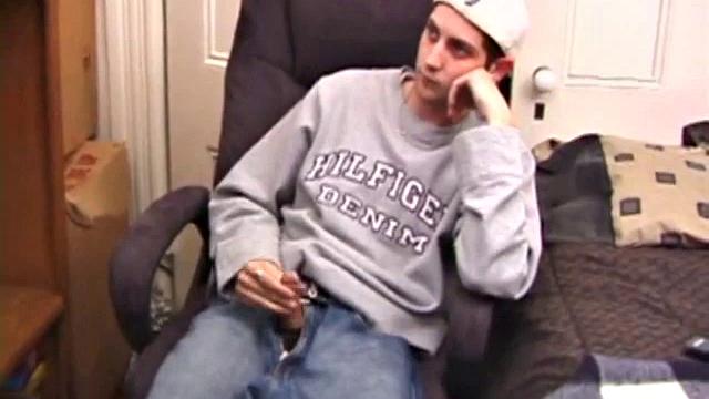 As a porn flick plays, young amateur Aaron Michaels strokes hard, pulls his cock out of his jeans, lets loose, and spills his nut on the bed.