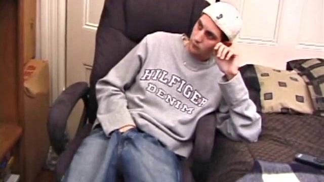 As a porn flick plays, young amateur Aaron Michaels strokes hard, pulls his cock out of his jeans, lets loose, and spills his nut on the bed.