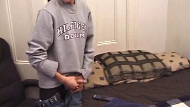 As a porn flick plays, young amateur Aaron Michaels strokes hard, pulls his cock out of his jeans, lets loose, and spills his nut on the bed.