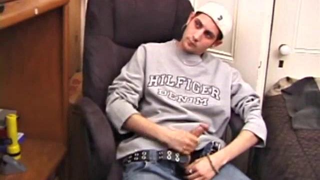 As a porn flick plays, young amateur Aaron Michaels strokes hard, pulls his cock out of his jeans, lets loose, and spills his nut on the bed.