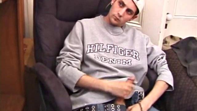 As a porn flick plays, young amateur Aaron Michaels strokes hard, pulls his cock out of his jeans, lets loose, and spills his nut on the bed.