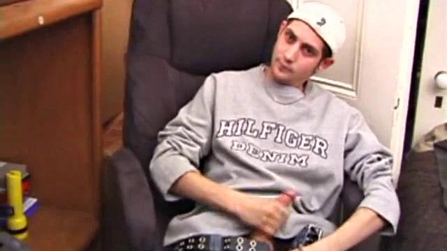 As a porn flick plays, young amateur Aaron Michaels strokes hard, pulls his cock out of his jeans, lets loose, and spills his nut on the bed.