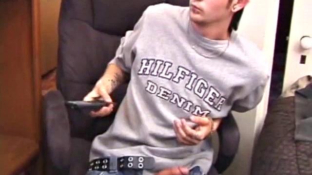 As a porn flick plays, young amateur Aaron Michaels strokes hard, pulls his cock out of his jeans, lets loose, and spills his nut on the bed.