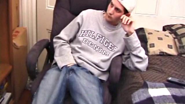 As a porn flick plays, young amateur Aaron Michaels strokes hard, pulls his cock out of his jeans, lets loose, and spills his nut on the bed.