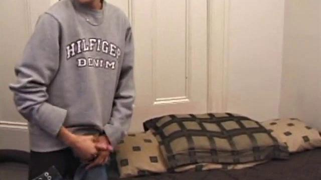 As a porn flick plays, young amateur Aaron Michaels strokes hard, pulls his cock out of his jeans, lets loose, and spills his nut on the bed.