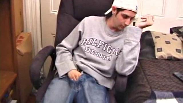 As a porn flick plays, young amateur Aaron Michaels strokes hard, pulls his cock out of his jeans, lets loose, and spills his nut on the bed.