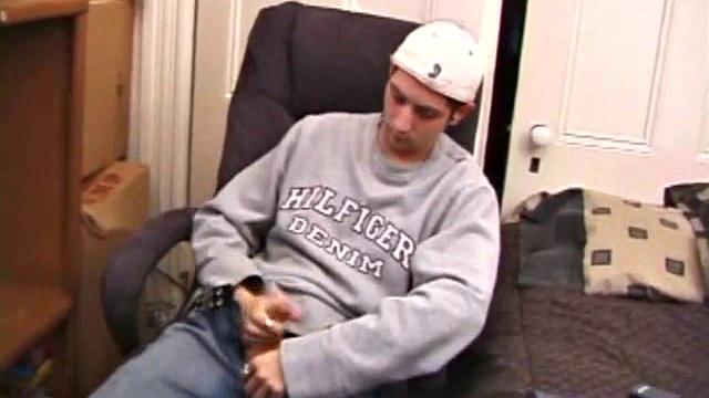 As a porn flick plays, young amateur Aaron Michaels strokes hard, pulls his cock out of his jeans, lets loose, and spills his nut on the bed.