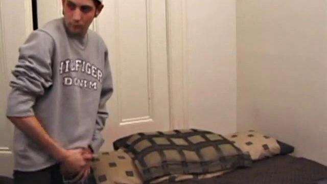 As a porn flick plays, young amateur Aaron Michaels strokes hard, pulls his cock out of his jeans, lets loose, and spills his nut on the bed.