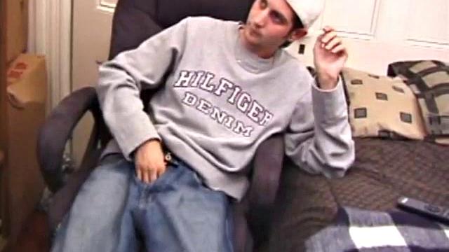 As a porn flick plays, young amateur Aaron Michaels strokes hard, pulls his cock out of his jeans, lets loose, and spills his nut on the bed.