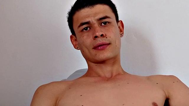 Skinny and smooth Dominic strips to his underwear and hops on a bed. There, he works up a stiff one and then removes his boxers. Kicked back on the bed, the young Latino starts masturbating.