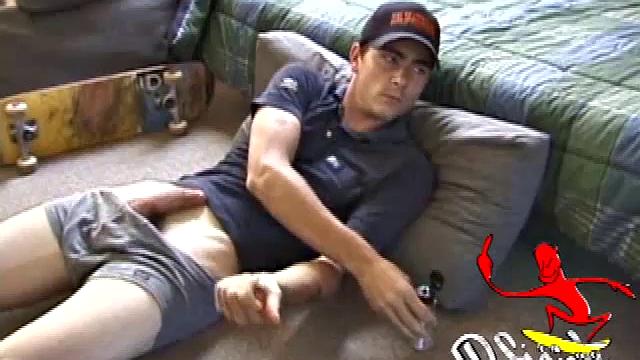 Dan gets down on the floor and turns on a video. He goes right for his cock and plays with himself until he's rock hard. Rolling the head with his palm Dan lubes up his cock.