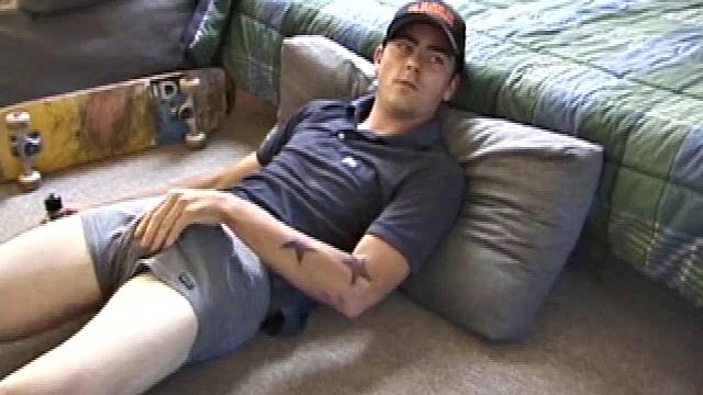 Dan gets down on the floor and turns on a video. He goes right for his cock and plays with himself until he's rock hard. Rolling the head with his palm Dan lubes up his cock.