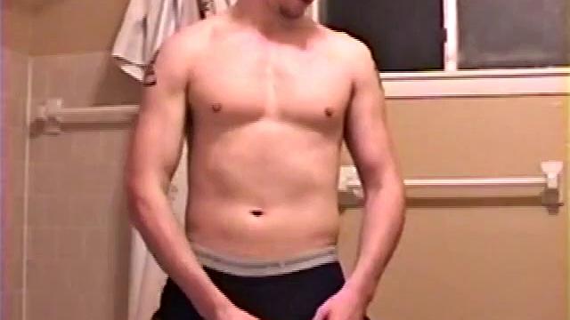 After a busy day Shawn is in the bathroom getting ready to shower and decides to play with himself through his pants. He strips and flexes for the camera, while stroking his hard cock, and soon Shawn blasts a warm cum load onto his chest.