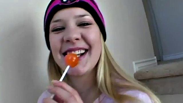 Blonde teen in pantyhose seduces with a lollipop while teasing you on the stairs