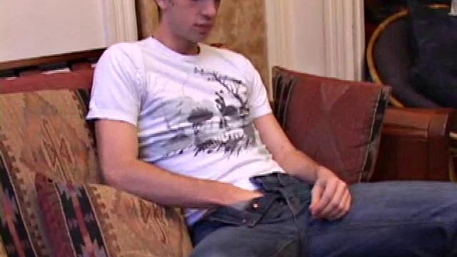 While watching a porn video, Gabriel Turner gets himself hard and then lubes his stiff dick for self-pleasuring.