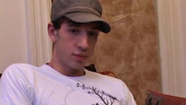 While watching a porn video, Gabriel Turner gets himself hard and then lubes his stiff dick for self-pleasuring.