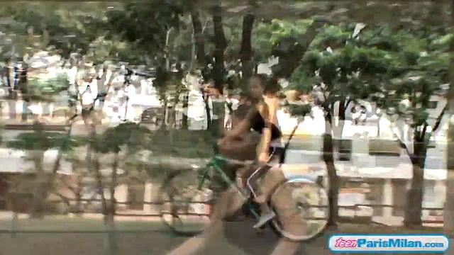 Busty teen riding her bike through the park