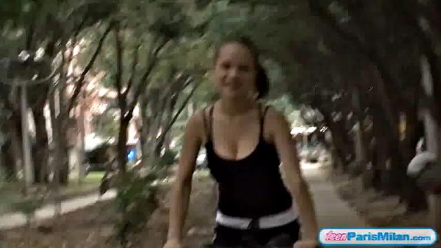 Busty teen riding her bike through the park