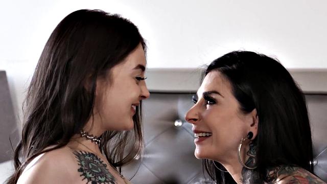 Busty lesbian MILF with pierced pussy gets doggy-styled by tattooed dyke with strap-on