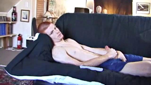 Tristan wastes time getting his dick out of his pants. He watches a porn video, pulling on his growing cock. Once boned up, he strokes with determination and explodes a gusher of warm cum.