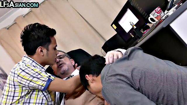 Gay businessman fucks Asian twinks in office 3some